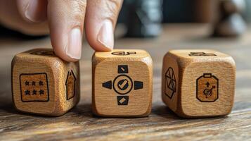 Hand Selecting Wooden Dice with Icons Ranking, House, Checkmark, Send, Productivity Symbols on Wood Table photo