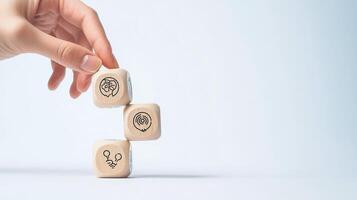 Hand Stacking Wooden Dice with Brain, Target, and Idea Icons on a Light Background, Representing Business Strategy photo