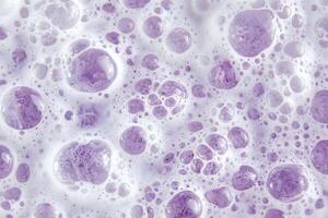 Bubbles of soft lilac foam present an abstract, textured surface for backgrounds and artistic projects photo