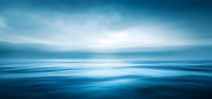 Calm blue ocean horizon extends to a soft, cloudy sky, revealing subtle atmospheric light photo