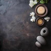 Candles stones and orchid flowers are arranged beautifully on a dark textured surface creating a relaxing ambiance photo