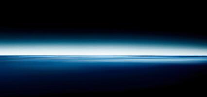 Deep blue water meets a gradient sky in this serene abstract ocean scene photo