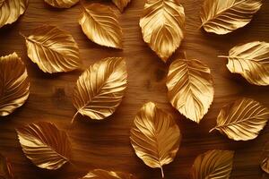 Golden leaf patterns are scattered beautifully on a wooden surface to create an elegant texture photo