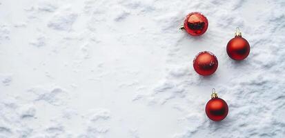 Vivid red Christmas baubles rest delicately upon a pristine, snowy expanse, suggesting winter serenity photo
