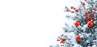 Snowcovered Christmas tree branches adorned with red ornaments and berries create a festive scene photo