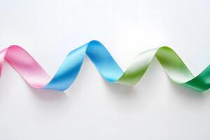 Colorful ribbon cascades across the white surface, displaying a beautiful transition from pink to green photo