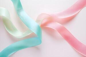 Gently intertwined pastel ribbons create a soft, elegant arrangement on a clean, white background photo