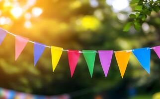 Colorful pennant flags hang on a string, creating a festive summer atmosphere in the park photo
