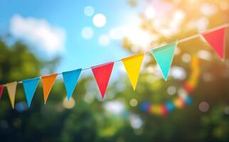 Festive party pennants strung between trees create a joyous, colorful outdoor atmosphere on a bright day photo