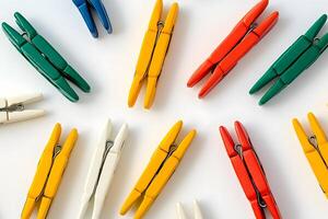 Several wooden clothes pins are neatly arranged showing colorful texture on a plain surface photo