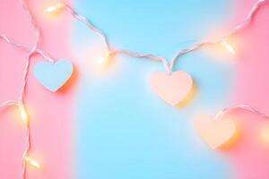 Heart shaped string lights elegantly drape against a dual pink and blue gradient background photo