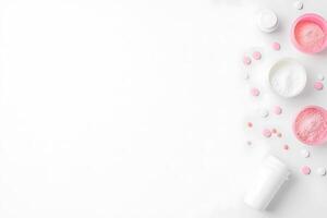 Pink and white powder supplements with tablets creatively placed on white background showcasing various containers photo