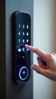 A person pressing the button on a smart door lock photo