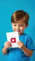 A child holding up a letter a card photo