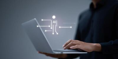 Man using laptop with icons on screen photo
