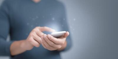A person holding a smart phone with a glowing screen photo