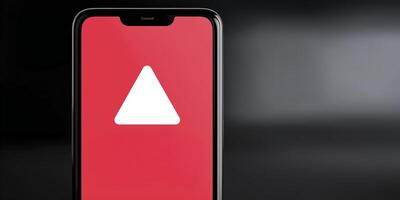 A smartphone with a red triangle on the screen photo