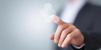 Business professional interacting with digital interface displaying hexagonal shapes and technology concepts for innovation and connectivity concept photo