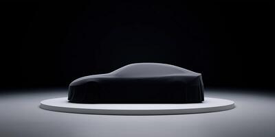 Sleek automobile covered with a black cloth on a circular platform in a dimly lit studio showcasing modern design and innovation concept photo