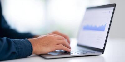 Hands typing on a laptop keyboard with data analytics displayed on the screen showcasing growth trends and business insights digital workspace concept photo