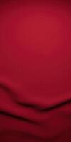 Elegant red fabric background with smooth texture and gentle folds creating a rich visual appeal for design projects and artistic expressions, fabric texture concept photo