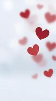 Red hearts floating gently against a soft blurred background, creating a romantic and dreamy atmosphere, perfect for expressing love and affection in various designs photo