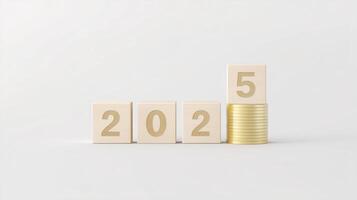 Wooden blocks displaying the year 2025 next to a stack of gold coins, symbolizing financial growth and future investment opportunities in a minimalist setting photo
