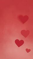 Red hearts of various sizes are scattered across a soft red background, creating a romantic and warm atmosphere, perfect for love-themed designs and celebrations photo