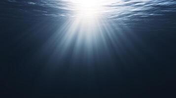 Underwater scene with sunlight filtering through water surface, creating beautiful rays and illuminating dark depths, showcasing the serene beauty of aquatic environments photo