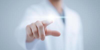 Innovative healthcare professional reaching out with a finger towards a glowing light, symbolizing technology and advancement in medical practices, healthcare concept photo