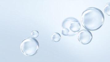 Transparent water bubbles floating gracefully on a soft blue background creating a serene and calming atmosphere for various design applications photo