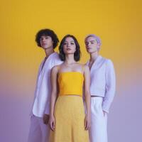 Group of three stylish individuals posing confidently against a vibrant yellow background showcasing modern fashion trends and diverse styles in a contemporary setting photo