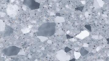 Textured gray terrazzo flooring featuring a mix of white and dark stone chips, creating a modern and stylish surface ideal for contemporary interior design projects photo