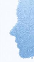 Abstract representation of a human face created with blue water droplets, showcasing the interplay of light and texture against a soft white background, evoking emotions and thoughts photo