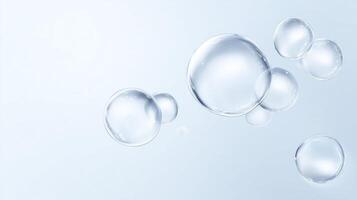 Transparent soap bubbles floating gracefully against a soft blue background, creating a serene and calming atmosphere, ideal for various design projects and creative uses photo