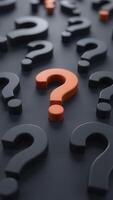 Many question marks are scattered on a black surface photo