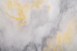 Abstract yellow and gray marble texture with cloudy patterns photo