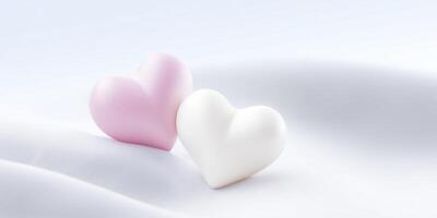 Two heart-shaped objects, one pink and one white, resting on a soft, flowing fabric surface, creating a romantic and serene atmosphere for love and affection themes photo