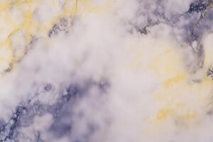 Elegant marble texture with gold veins and soft cloudy patterns photo