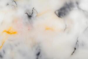 Abstract marble texture with soft white and yellow veining patterns photo