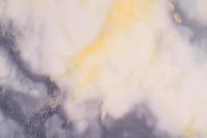 Abstract marble texture with white, yellow, and gray patterns in closeup view photo
