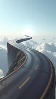 Road winding through clouds towards the sun above a cliff photo