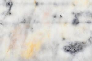Abstract marble texture with soft white, grey, and subtle yellow patterns photo