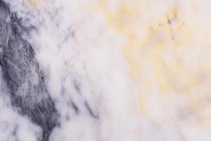 Abstract marble texture with yellow and gray patterns photo