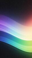 Colorful abstract waves of light in gradient spectrum on dark background photo