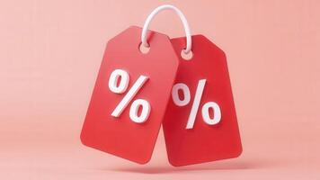 Two red discount tags hanging on pink background showing percentage symbol photo