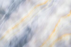 Elegant marble texture with subtle gold and gray veins photo