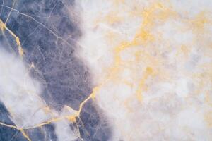 Stunning abstract marble texture with gold veins in blue and white tones photo