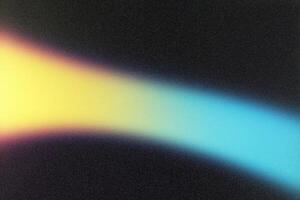Light beam creating colorful gradient on black background photo