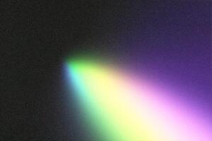 Light beam creating colorful gradient on black grainy background photo
